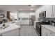 Spacious kitchen with white cabinets, stainless steel appliances, and quartz countertops at 2734 E Birchwood Pl, Chandler, AZ 85249