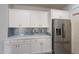 Kitchen with white cabinets, stainless steel refrigerator, and blue tile backsplash at 2734 E Birchwood Pl, Chandler, AZ 85249