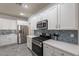 Bright kitchen with stainless steel appliances and white cabinets at 2734 E Birchwood Pl, Chandler, AZ 85249