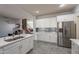 Modern kitchen with stainless steel appliances and white cabinets at 2734 E Birchwood Pl, Chandler, AZ 85249