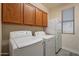 Bright laundry room, washer, dryer, and cabinets at 2734 E Birchwood Pl, Chandler, AZ 85249