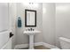 Elegant powder room with pedestal sink and modern toilet at 2800 E Portola Valley Dr, Gilbert, AZ 85297