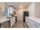 Modern kitchen with white cabinets, stainless steel appliances, and quartz countertops at 3710 W Irma Ln, Glendale, AZ 85308