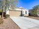 House exterior showcasing a brown garage door and drought-tolerant landscaping at 3841 N 293Rd Dr, Buckeye, AZ 85396