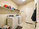 Laundry room with washer, dryer, and ample shelving at 3841 N 293Rd Dr, Buckeye, AZ 85396