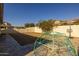 A backyard with a dome climber and basketball hoop for Gathering fun, with a view of the surrounding neighborhood at 4747 S Aileron Ln, Mesa, AZ 85212