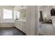 Bright bathroom features a soaking tub, white vanity, dark tile floor, and open access to the bedroom at 4747 S Aileron Ln, Mesa, AZ 85212