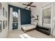 Bedroom with a blue accent wall and an arched window with white curtains at 4747 S Aileron Ln, Mesa, AZ 85212