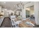 Open dining area with modern light fixture, seamless transition to the kitchen and sliding door to the backyard at 4747 S Aileron Ln, Mesa, AZ 85212