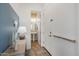 Hallway view of a powder room, with neutral decor at 4747 S Aileron Ln, Mesa, AZ 85212