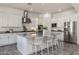 Modern white kitchen featuring granite countertops, stainless steel appliances, and a large kitchen island at 4747 S Aileron Ln, Mesa, AZ 85212