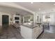 Open concept kitchen with granite counters, stainless appliances, and a view of the living and dining areas at 4747 S Aileron Ln, Mesa, AZ 85212