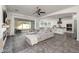 Open-concept living room with a large sectional, tile floors, and access to the outdoor patio and updated kitchen at 4747 S Aileron Ln, Mesa, AZ 85212