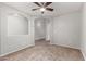 Large bedroom with neutral carpeting and ceiling fan at 5001 S 236Th Dr, Buckeye, AZ 85326