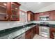 Modern kitchen with dark wood cabinets and granite countertops at 5001 S 236Th Dr, Buckeye, AZ 85326