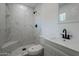 Clean bathroom with marble-look tile shower and white vanity at 5039 N 18Th Ave, Phoenix, AZ 85015