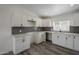 Modern kitchen with white cabinets and gray backsplash at 5039 N 18Th Ave, Phoenix, AZ 85015