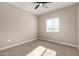 Well-lit bedroom with carpeted floors and ceiling fan at 509 N Lincoln Ave, Casa Grande, AZ 85122