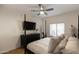 Main bedroom features a post bed, ceiling fan, and large TV at 5450 E Deer Valley Dr # 1004, Phoenix, AZ 85054