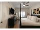 Bright bedroom with a comfortable post bed and ceiling fan at 5450 E Deer Valley Dr # 1004, Phoenix, AZ 85054