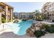 Resort-style pool with lounge chairs and waterfall at 5450 E Deer Valley Dr # 1004, Phoenix, AZ 85054