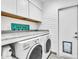 Bright laundry room with washer, dryer, and ample storage at 6235 E Larkspur Dr, Scottsdale, AZ 85254