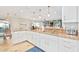 Open kitchen with granite counters, white cabinets and a view into living room at 6836 E Ludlow Dr, Scottsdale, AZ 85254