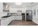Updated kitchen with white cabinets, granite countertops, and stainless steel appliances at 7416 E Holly St, Scottsdale, AZ 85257