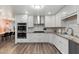 Modern kitchen featuring white cabinets, granite counters and stainless steel appliances at 7416 E Holly St, Scottsdale, AZ 85257