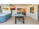 Outdoor patio with hot tub, dining table, and TV at 7416 E Holly St, Scottsdale, AZ 85257