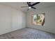 Simple bedroom with ceiling fan and large window at 750 E Northern Ave # 1053, Phoenix, AZ 85020