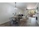 Bright dining area with a wooden table and metal chairs, adjacent to living room at 750 E Northern Ave # 1053, Phoenix, AZ 85020