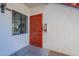 Condo entrance with a red security door and a window at 750 E Northern Ave # 1053, Phoenix, AZ 85020