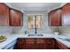 Modern kitchen with stainless steel appliances and wood cabinets at 750 E Northern Ave # 1053, Phoenix, AZ 85020