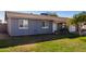 Single story home with gray exterior, landscaping, and driveway at 7749 W Orange Dr, Glendale, AZ 85303