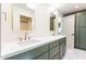 Modern bathroom with double vanity and green cabinets at 7806 E San Carlos Rd, Scottsdale, AZ 85258