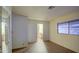 Bright bedroom with wood floors and built-in mirrored closet at 816 S Esperanza Ave, Mesa, AZ 85208