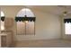 Spacious dining area with arched window and chandelier at 8450 W Rose Pilar Ct, Peoria, AZ 85382