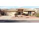 Tan house with tile roof, landscaping, and two car garage at 8450 W Rose Pilar Ct, Peoria, AZ 85382