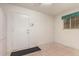 Bright laundry room with tile floor, door, and window at 8450 W Rose Pilar Ct, Peoria, AZ 85382