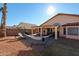 Spacious backyard featuring a covered patio and grassy area at 9818 W Mohawk Ln, Peoria, AZ 85382