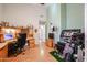 Spacious home office with wood-tone desk and cabinets, offering a functional workspace at 9818 W Mohawk Ln, Peoria, AZ 85382