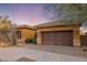 Single-story home with desert landscaping and two-car garage at 9887 E Edgestone Dr, Scottsdale, AZ 85255