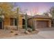 Single-story home with desert landscaping and two-car garage at 9887 E Edgestone Dr, Scottsdale, AZ 85255