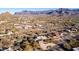 Aerial view showcasing a house with solar panels and a mountain backdrop at 10400 E Breathless Ave, Gold Canyon, AZ 85118