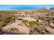 Aerial view showcasing a beautiful home with solar panels and a mountain backdrop at 10400 E Breathless Ave, Gold Canyon, AZ 85118