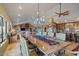 Long wooden dining table with seating for many, located in an open concept space at 10400 E Breathless Ave, Gold Canyon, AZ 85118