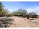 Gravel driveway leading to a gated entrance at 10400 E Breathless Ave, Gold Canyon, AZ 85118