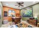 Home office with wood desk and large artwork at 10400 E Breathless Ave, Gold Canyon, AZ 85118