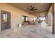 Spacious covered patio with tile flooring, seating, and ceiling fan at 10400 E Breathless Ave, Gold Canyon, AZ 85118